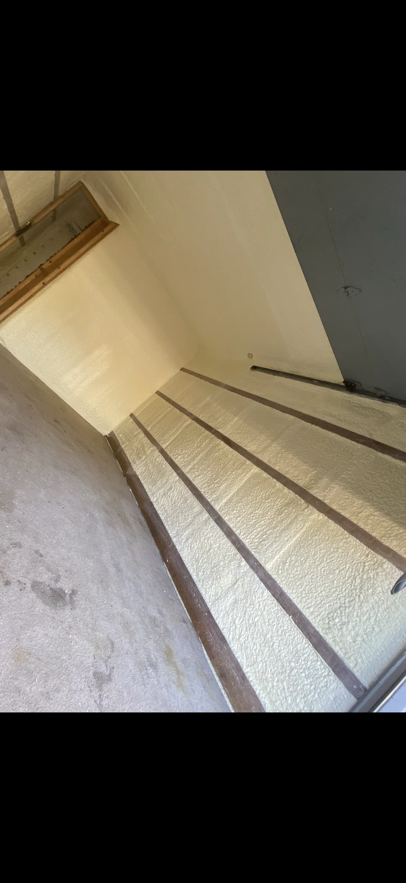 Fiberglass batt insulation between floor joists with new drywall ceiling installation