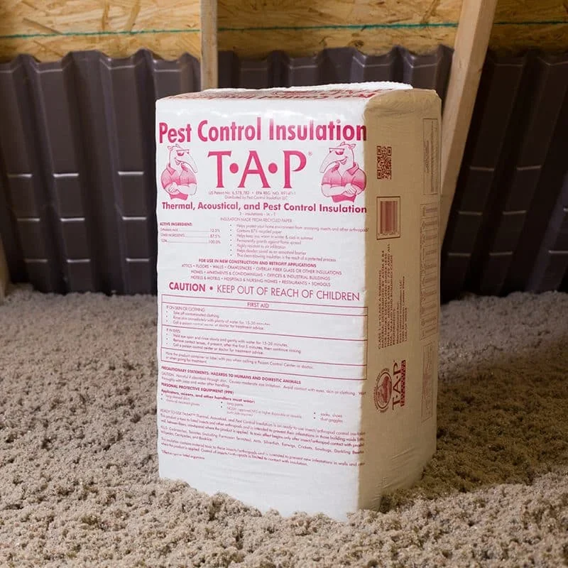 TAP pest control insulation batts installed in attic with wooden framing and dark roofing visible