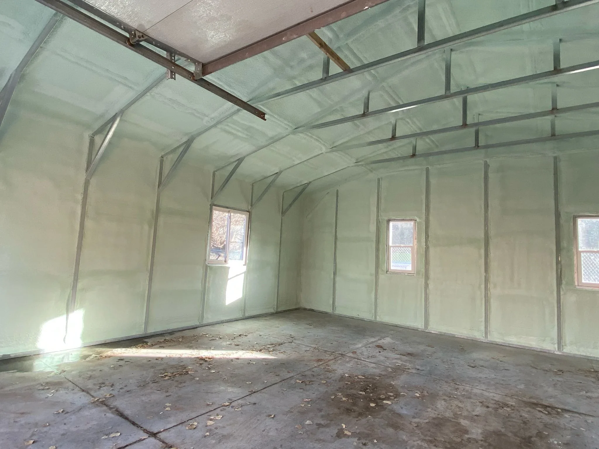 Fiberglass batt insulation installed in garage walls and ceiling with metal framing
